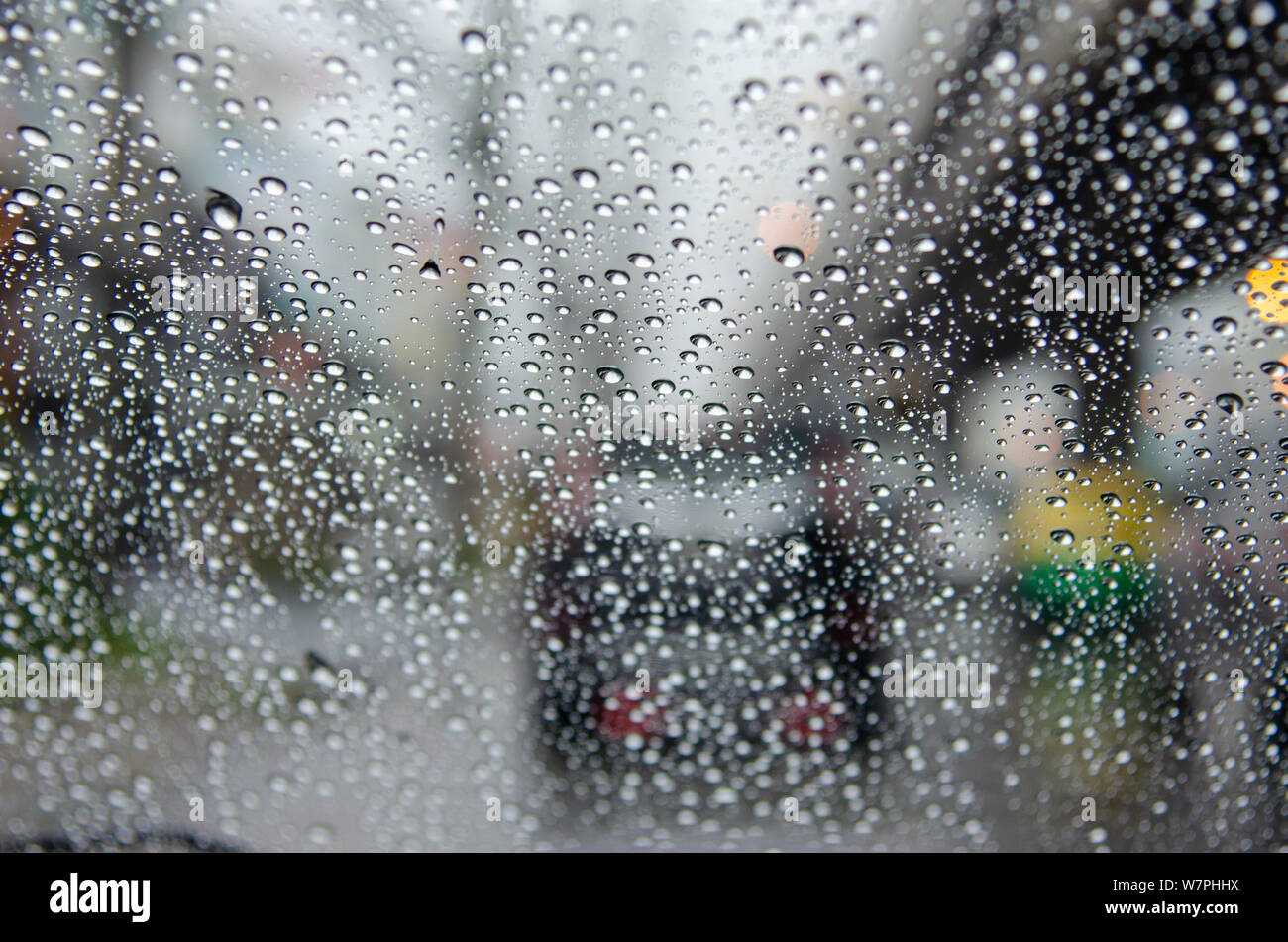 Car Window Raining car window with rain drops driving in rain.Traffic jam background ...