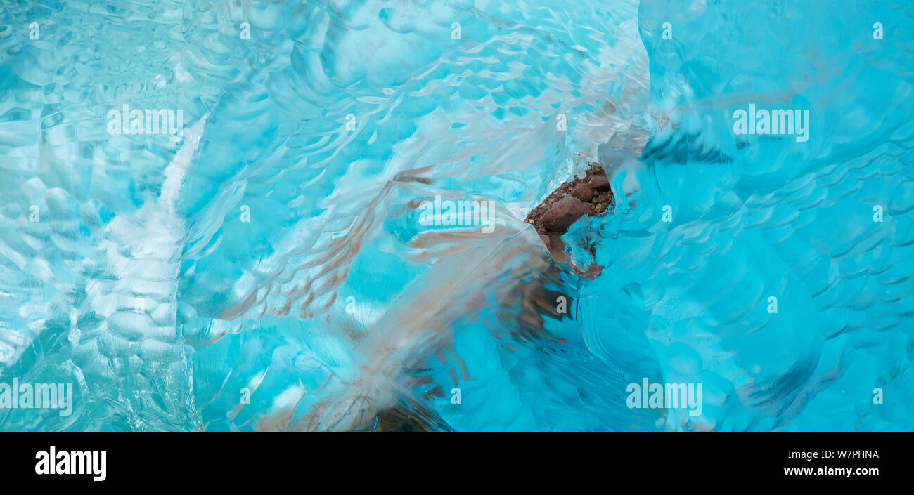 Detail of blue iceberg with bits of gravel included drifting off Brasvellbreen glacier, Austfonna, Nordaustlandet, Svalbard, Norway Stock Photo