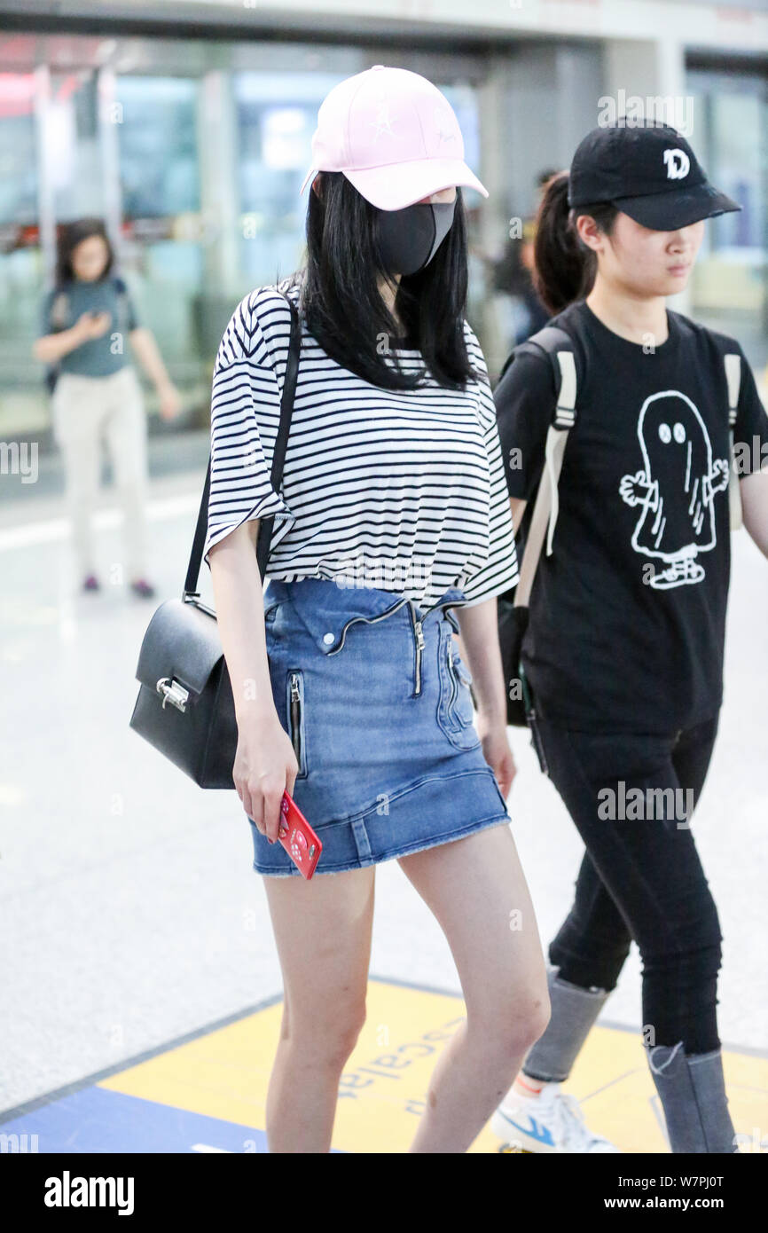 Chinese actress Yang Mi is pictured at the Beijing Capital International Airport in Beijing, China, 29 June 2017.   Tee shirt: R13  Skirt: RtA  Shoes: Stock Photo