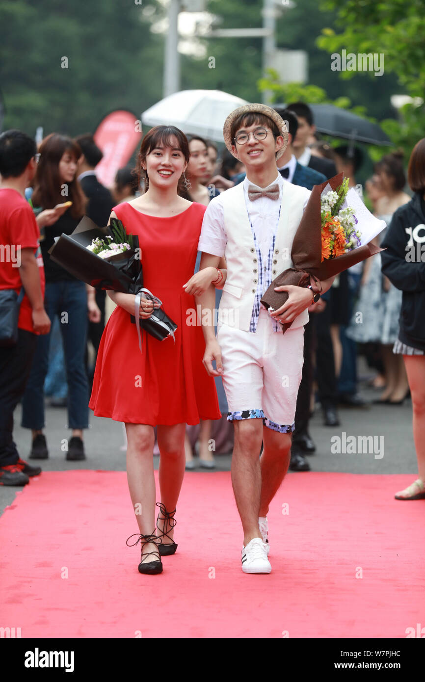 Students walk on the red carpet for a graduation party held by the Faculty of Science and Technology under the Communication University of China in Be Stock Photo