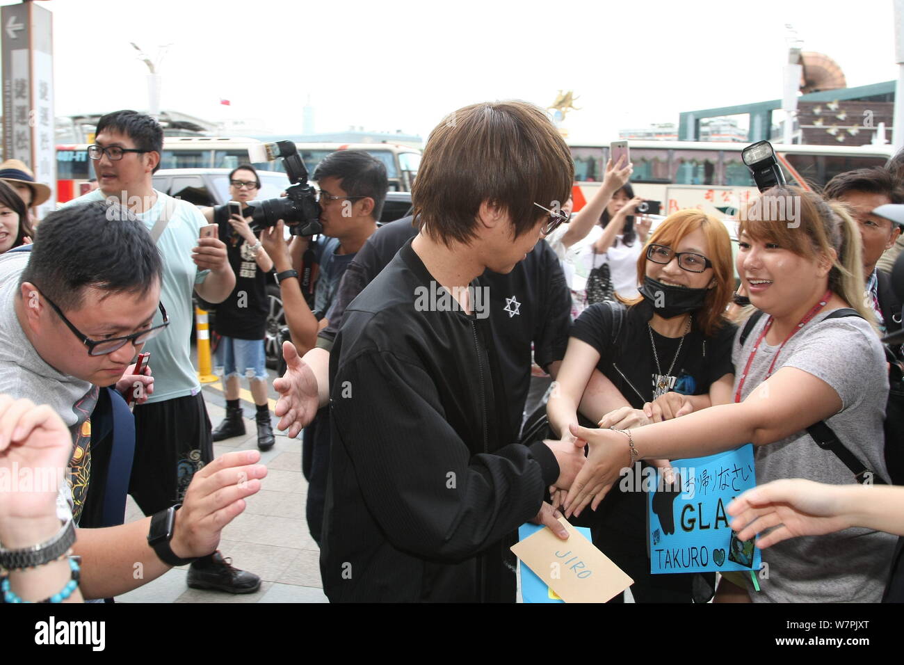 A Member Of Japanese Rock Band Glay Is Surrounded By Fans After Arriving At An Airport In Taipei Taiwan 22 June 17 Stock Photo Alamy