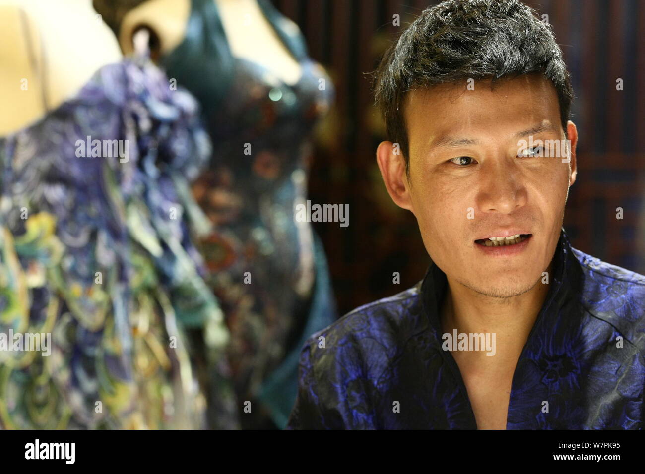 Chinese fashion designer Laurence Xu introduces embroidered cocktail dresses and jumpsuits of the haute couture collections at his atelier in Beijing, Stock Photo