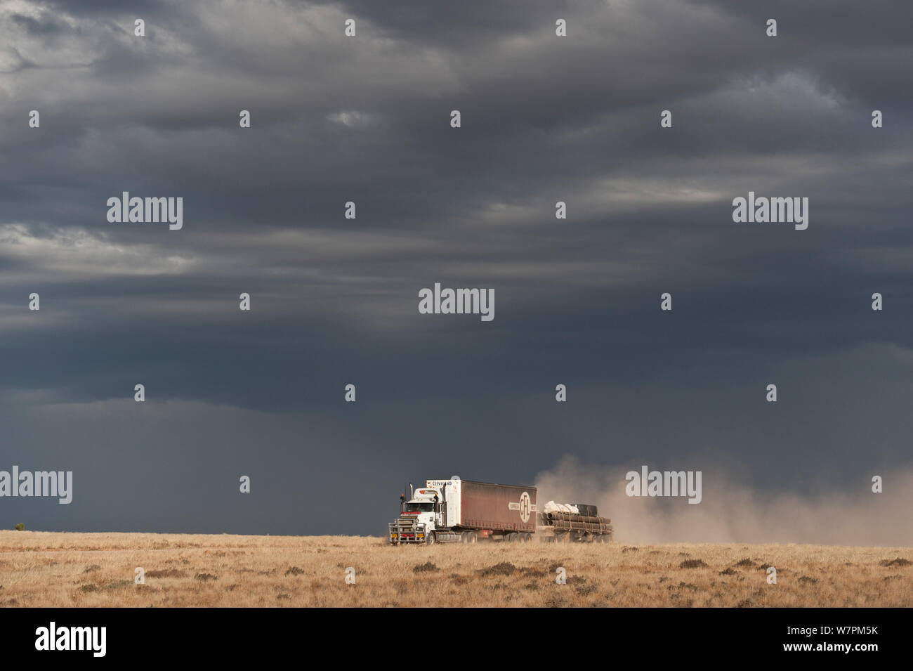 Bad weather looming ahead along the Strzelecki Track with a road train passing, South Australia Stock Photo