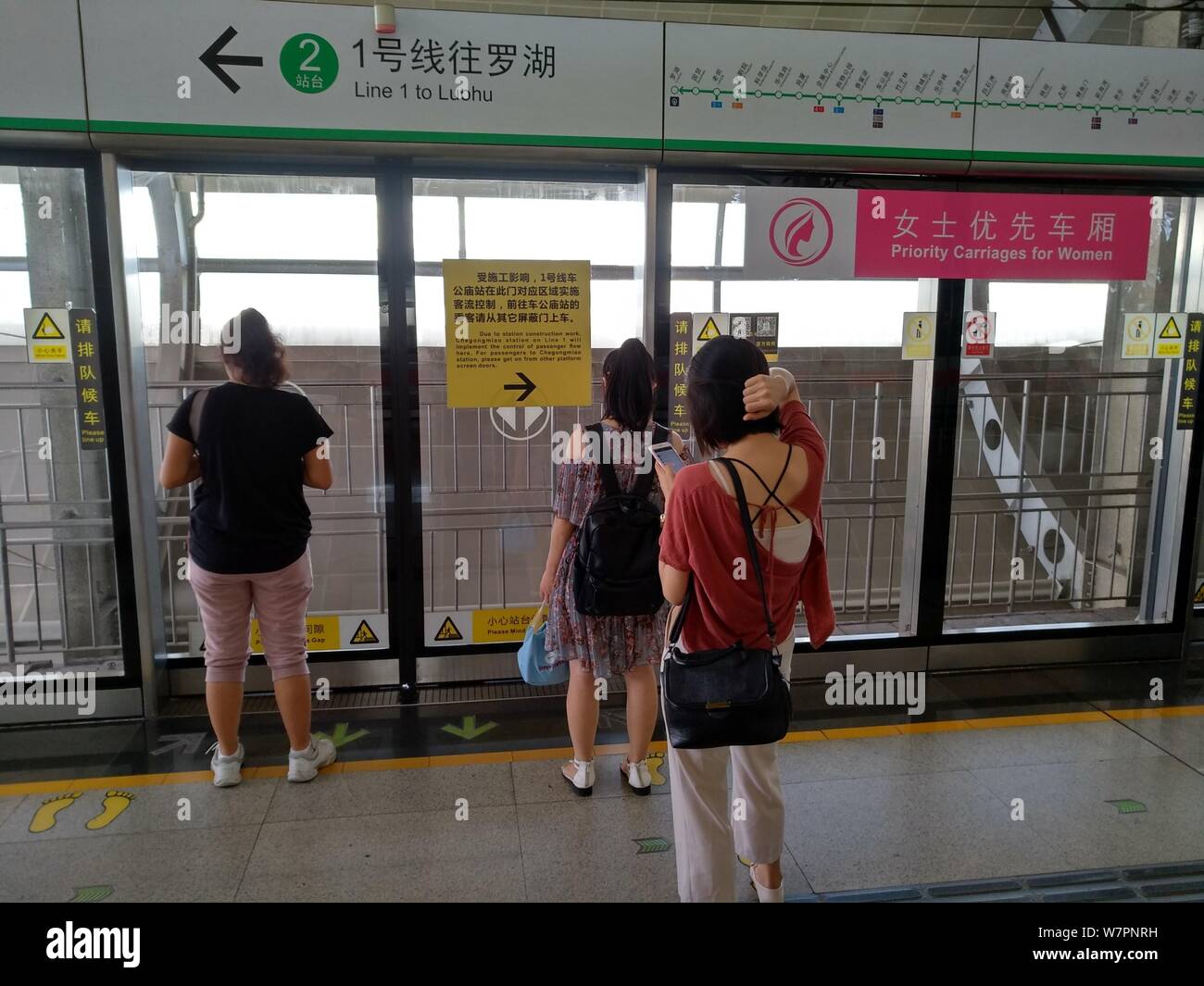 Female Passengers Wait For A Subway Train Next To A Signage Of Priority Carriages For Women At The Hourui Station On The Metro Line 1 In Shenzhen Ci Stock Photo Alamy
