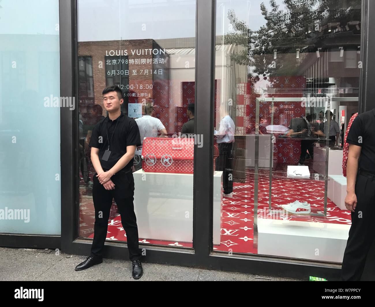 A security staff stands guard in front of a boutique of Louis