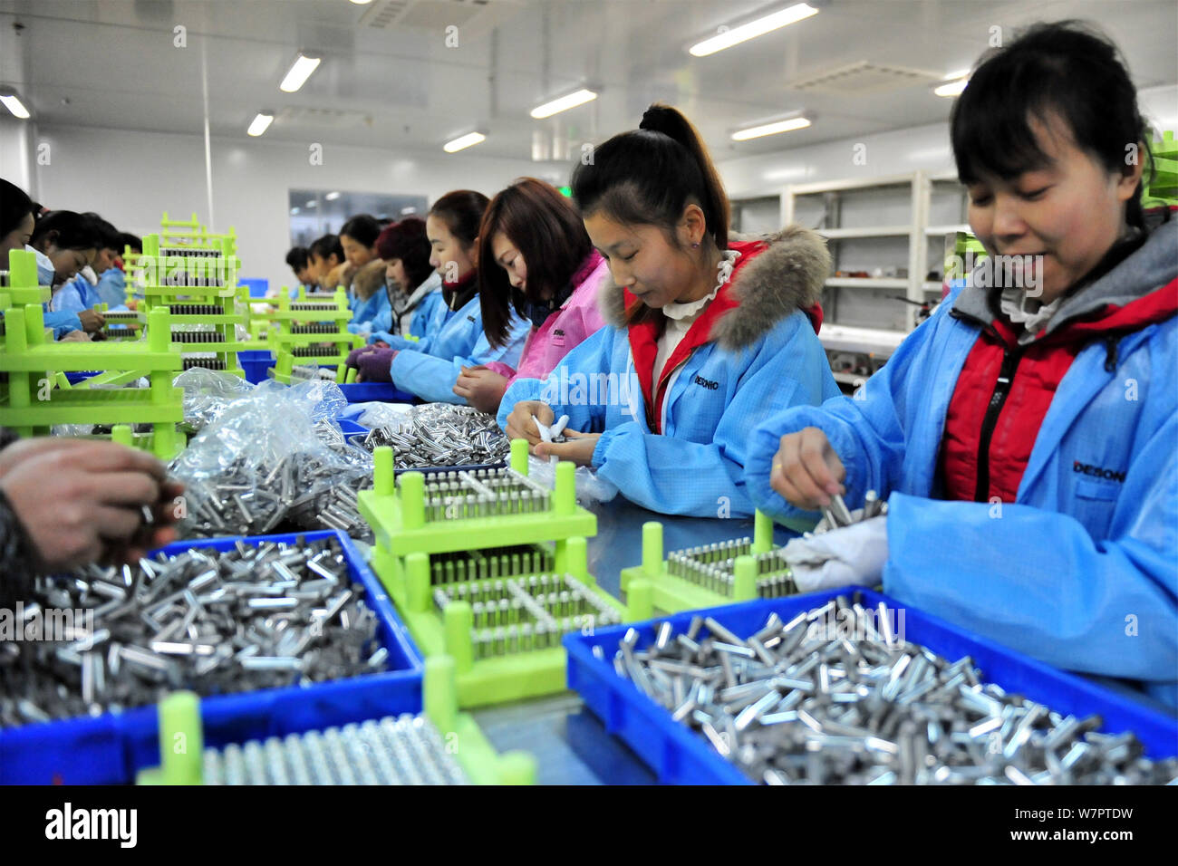 Female Chinese workers check the components of e cigarette to be