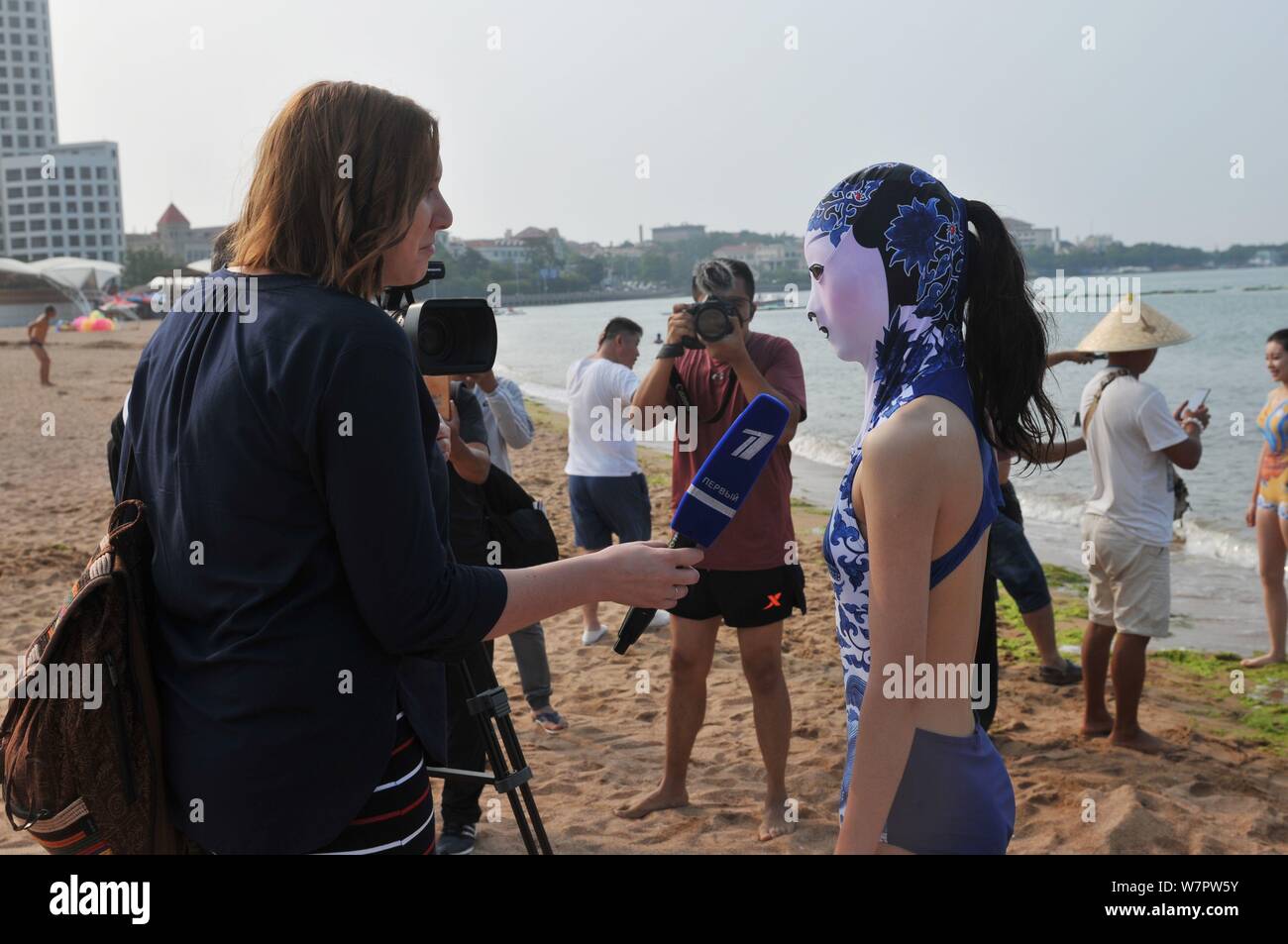 A model wearing a facekini swimsuit featuring blueandwhite porcelain