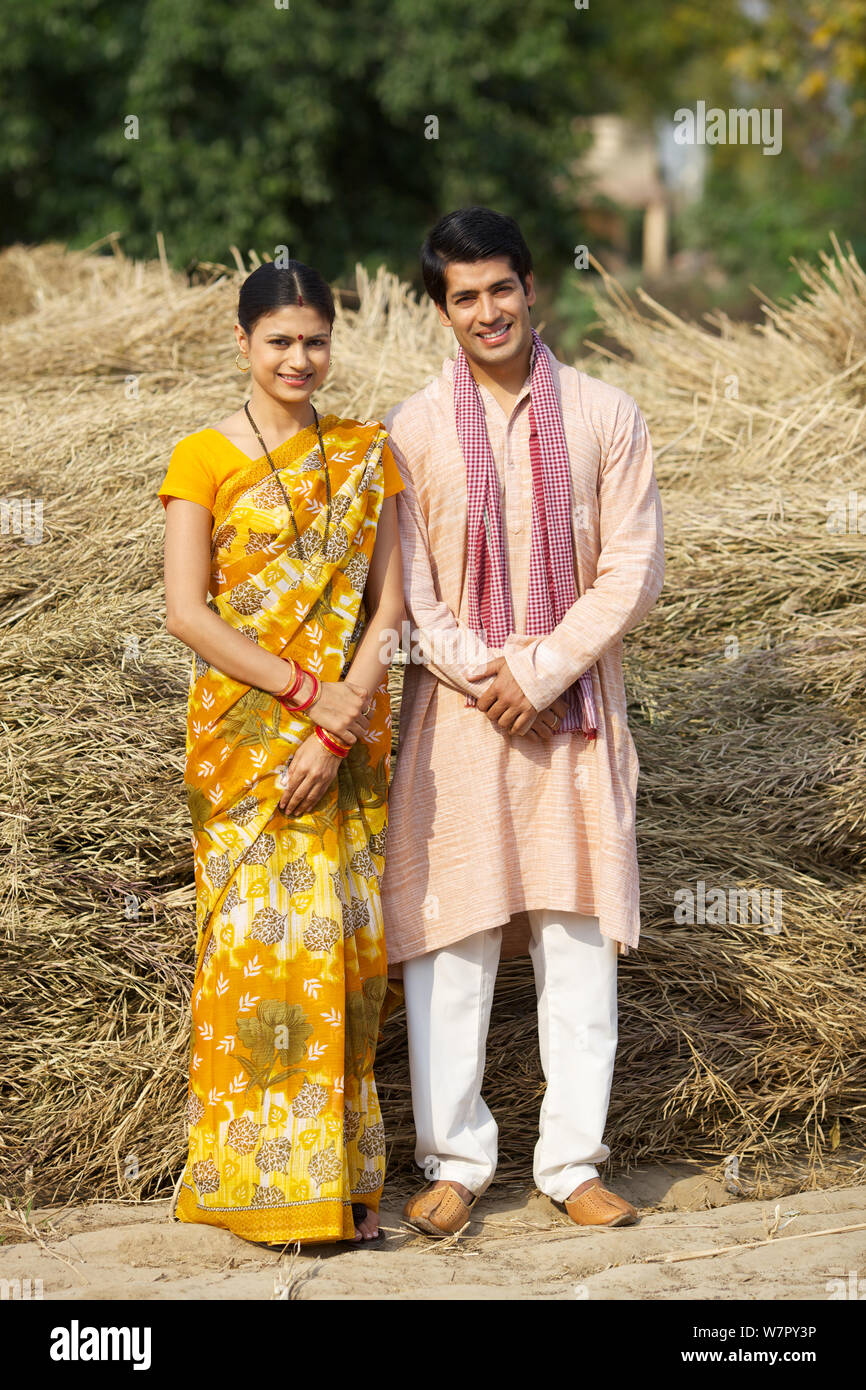 Rural couple standing in harvested crop Stock Photo - Alamy