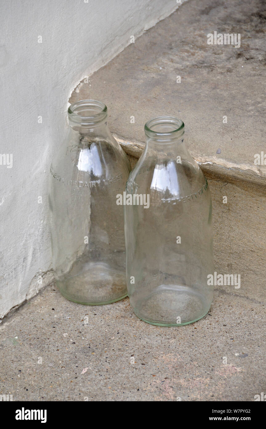 Two empty glass milk bottles on step, Holloway, London Borough of