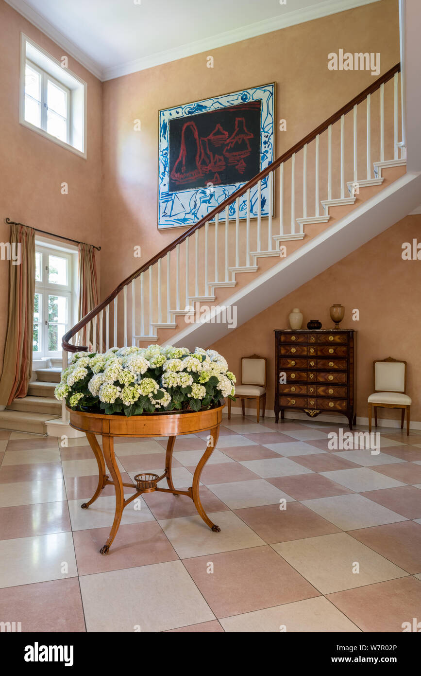 Flowers and modern art in entrance hall Stock Photo