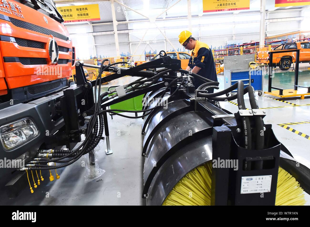 --FILE--A Chinese worker assembles cars on the assembly line at an auto ...