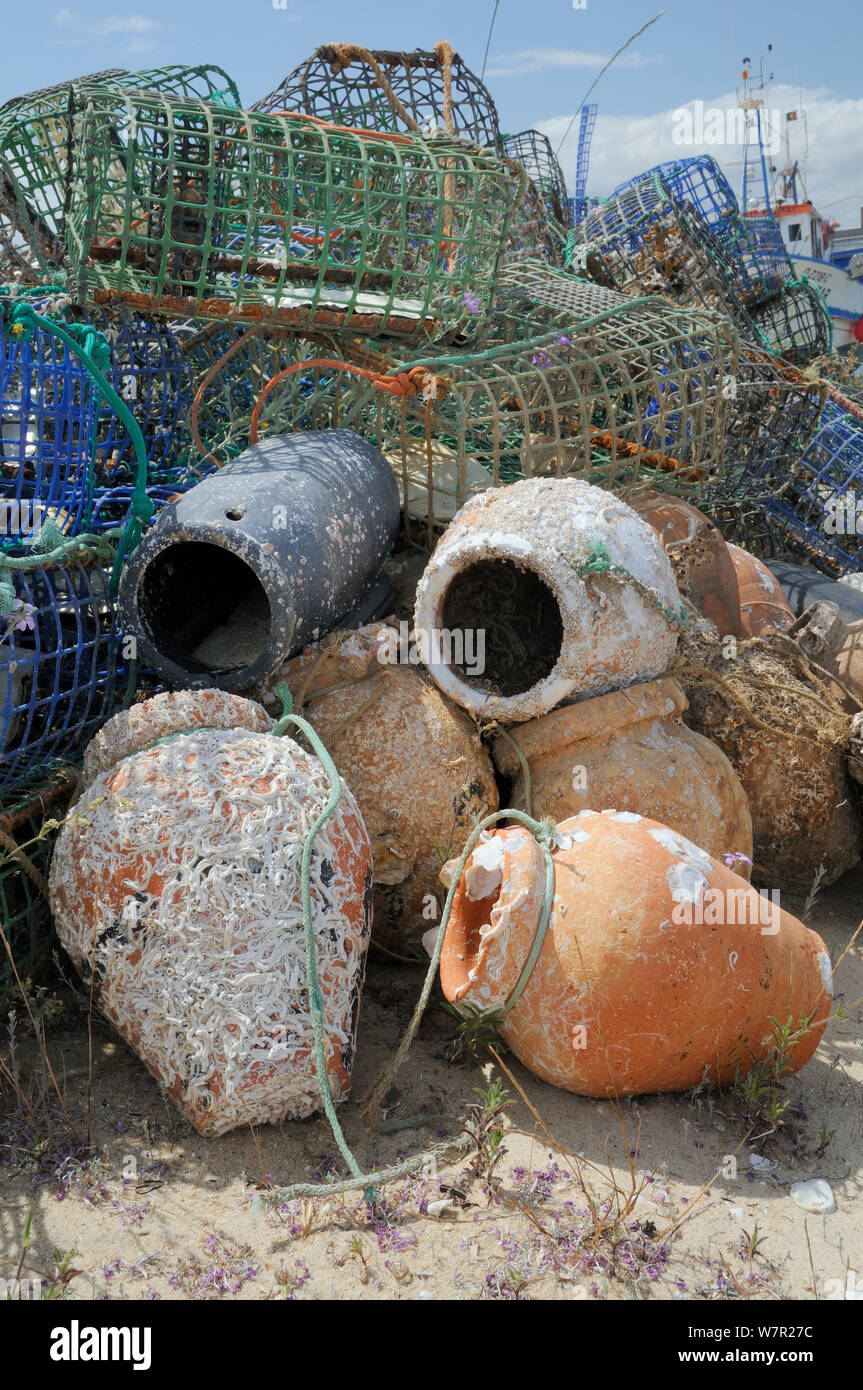 Stack of lobster pots and traditional ceramic Octopus pots encrusted with serpulid worm tubes and barnacles, Culatra island, Parque Natural da Ria Formosa, near Olhao, Algarve, Portugal, June. Stock Photo