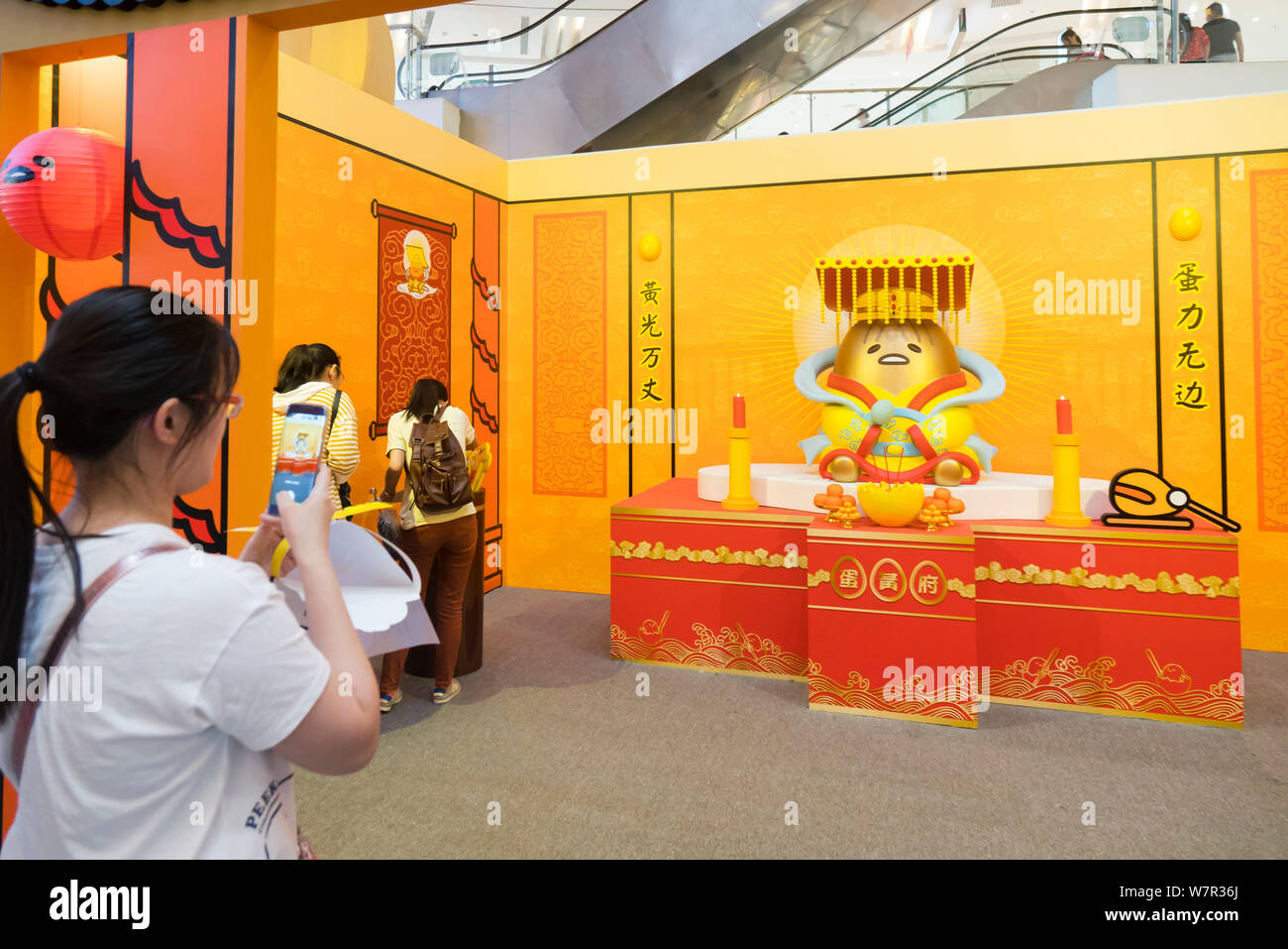 Cartoon enthusiasts takes photos of Gudetama, or lazy egg, created by Hello Kitty's developer Sanrio, in Shanghai, China, 19 June 2017.   The Japanese Stock Photo