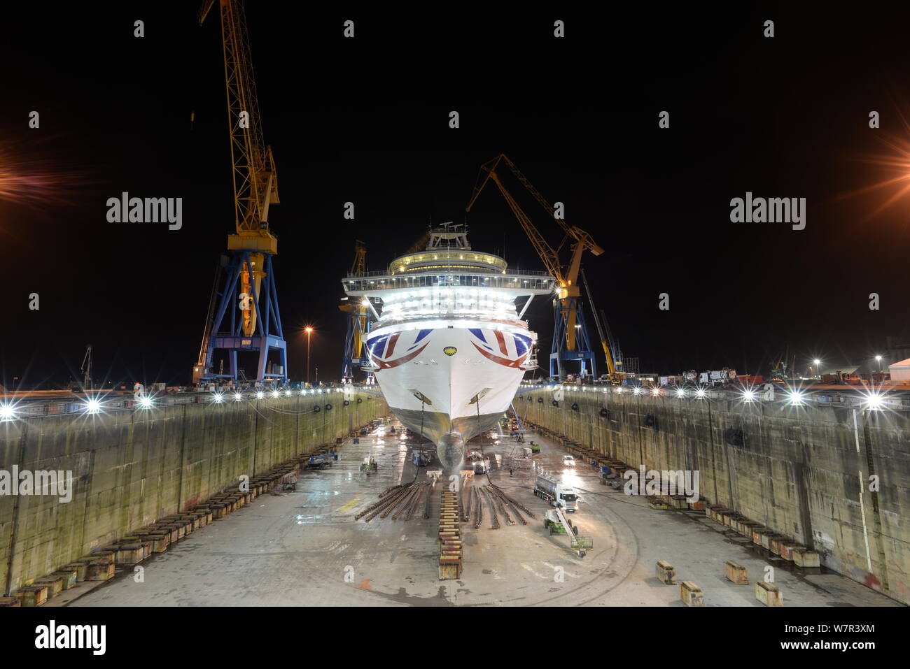 Wide view of full dry dock at night with P&O cruises ship Ventura illuminated in centre Stock Photo