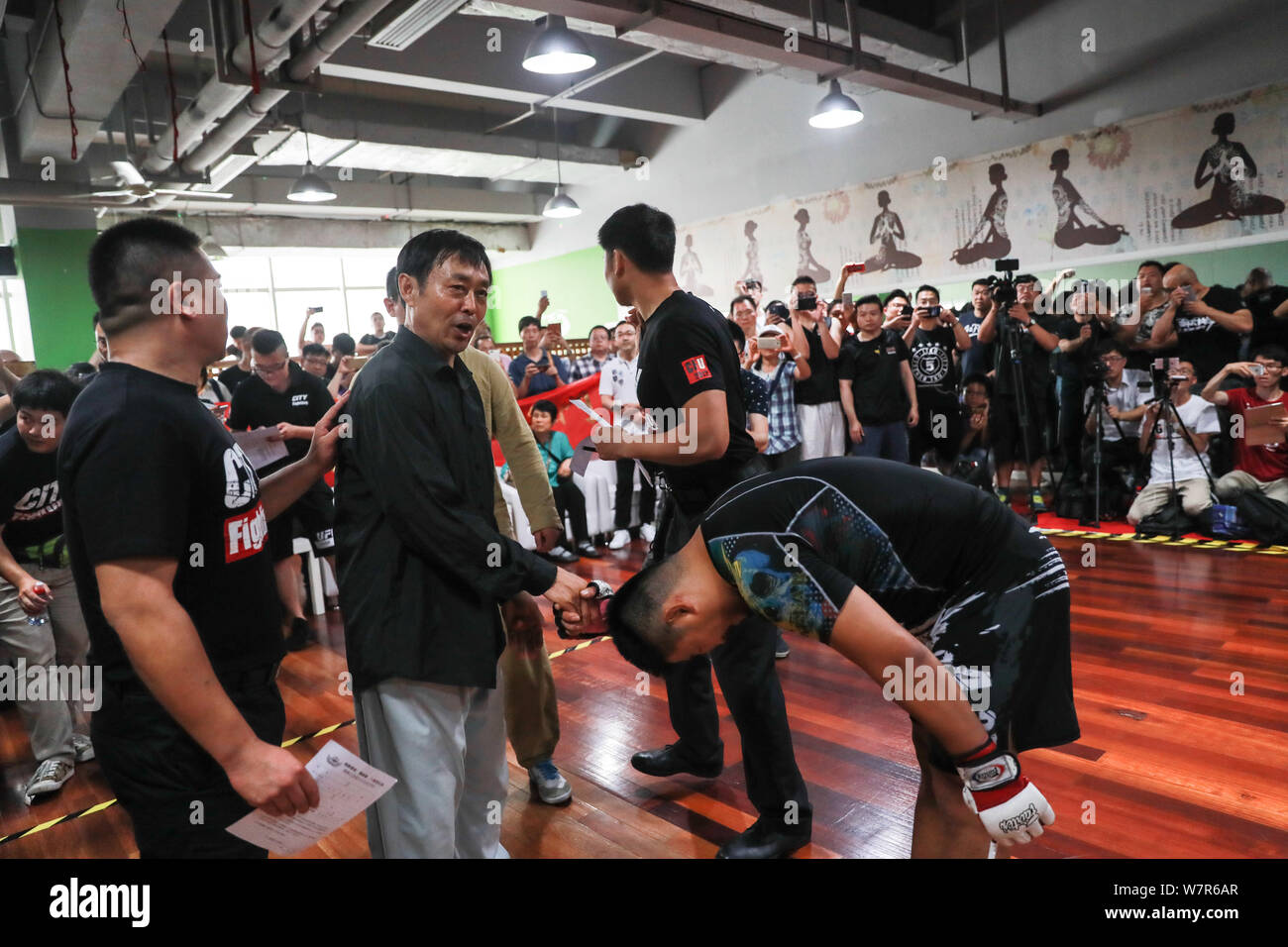 Retired mixed martial arts boxer Xu Xiaodong, right, interacts with Ma  Baoguo, center, a master of Chen style tai chi, at the planned mass brawl  site Stock Photo - Alamy