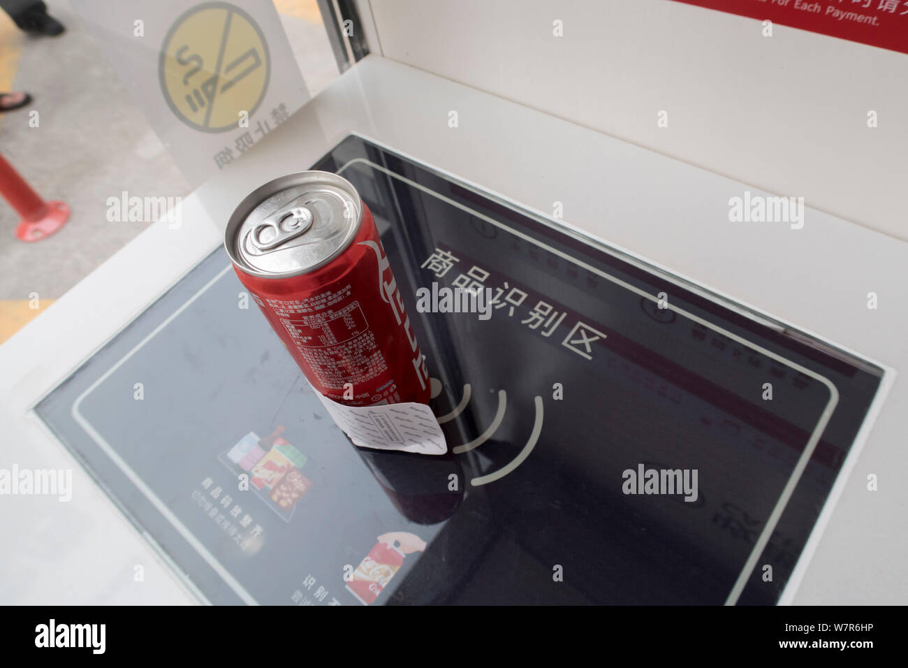 A can of CocaCola coke with an exclusive label is placed on electronic cashier to calculate the