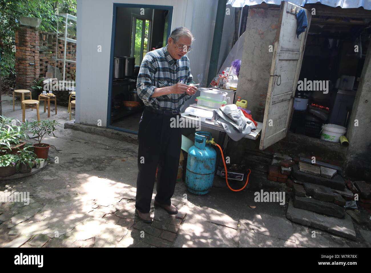 70 Year Old Japanese Man Koji Shimada Is Pictured In The Yard Of His