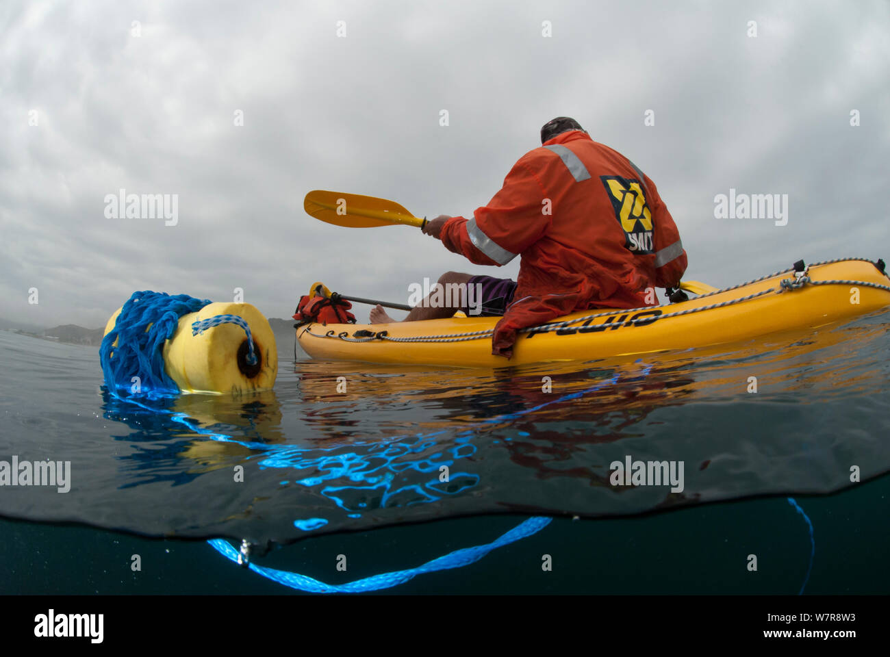 Man recreational fishing from a sea kayak for West coast rock lobster