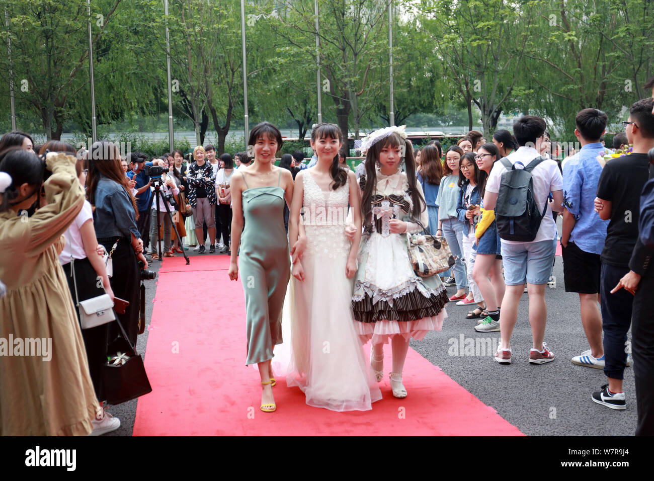 Students walk on the red carpet for a graduation party held by the Faculty of Science and Technology under the Communication University of China in Be Stock Photo