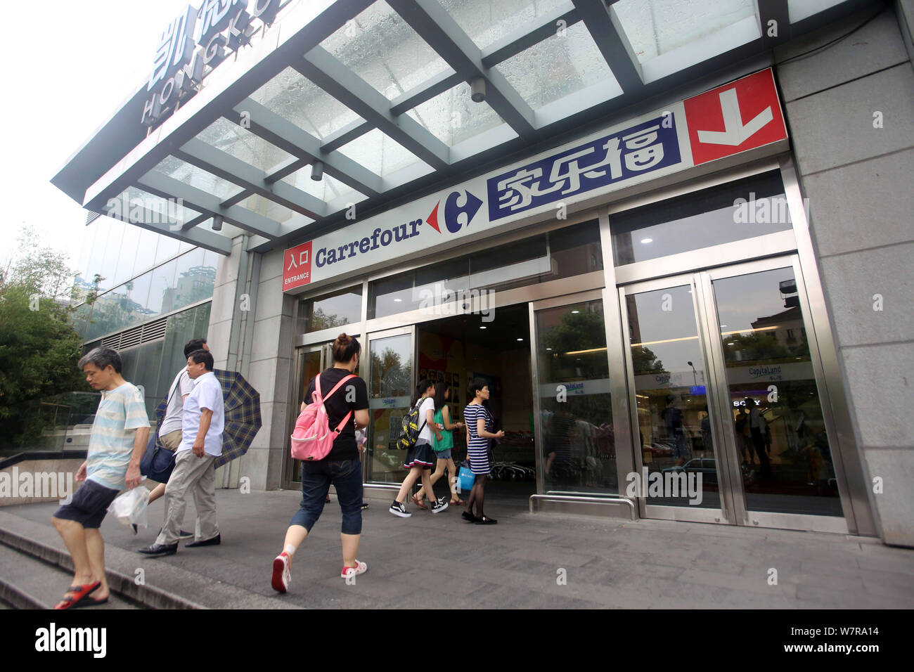 --FILE--Customers leave a supermarket of Carrefour in Shanghai, China, 3 August 2016.   French retailer Carrefour has removed dog meat products from t Stock Photo