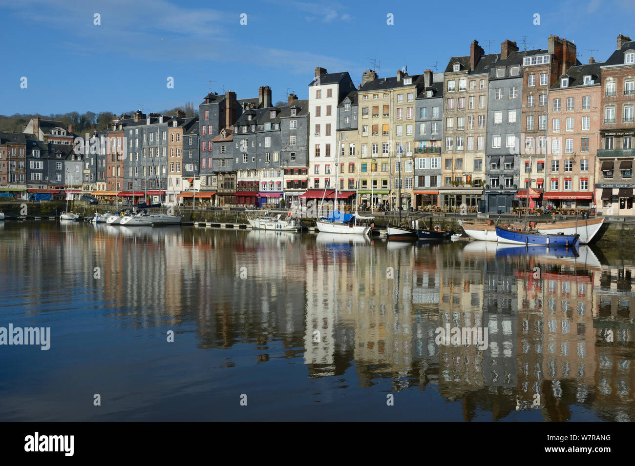 Honfleur harbour with boats and buildings reflected in the water, France, March 2013 Stock Photo
