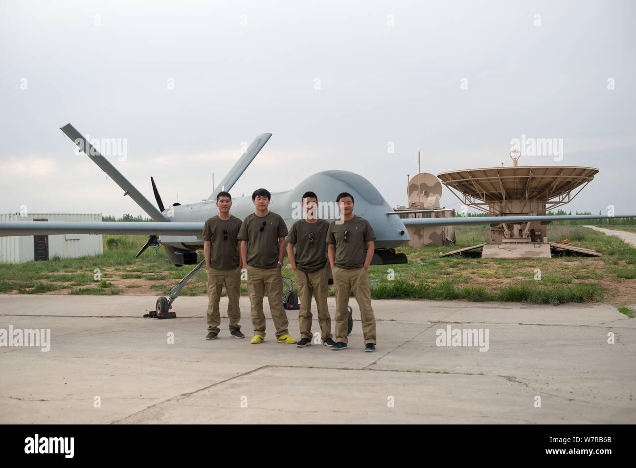 Chinese technicians pose with Cai Hong4 (CH4) unmanned aerial