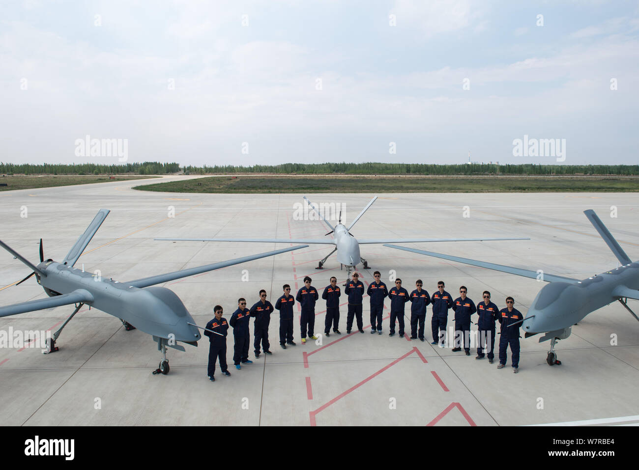 Chinese technicians pose with Cai Hong4 (CH4) unmanned aerial