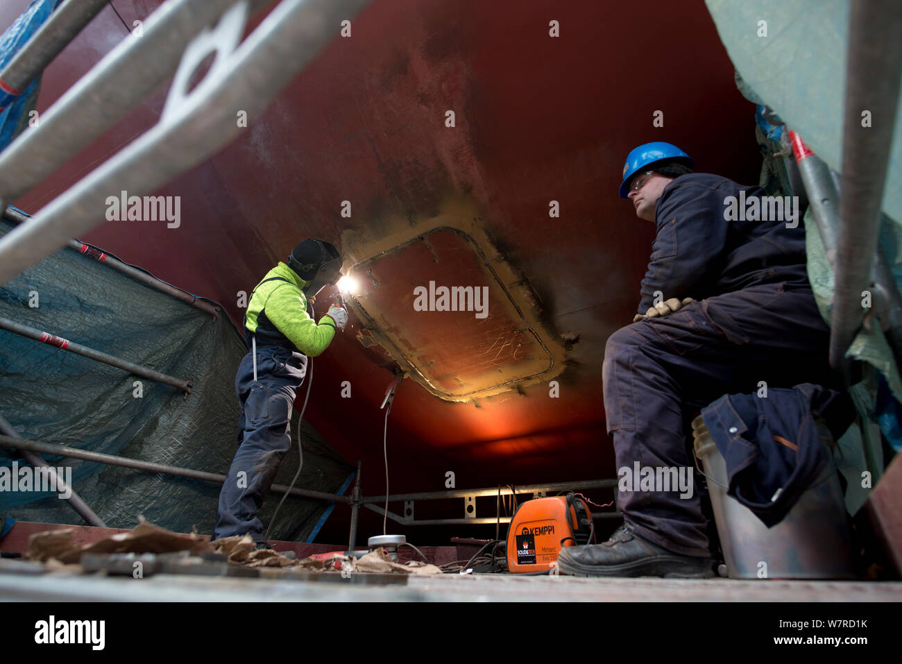 Welder Working On Underside Of Hull Of Large Ship Stock Photo Alamy