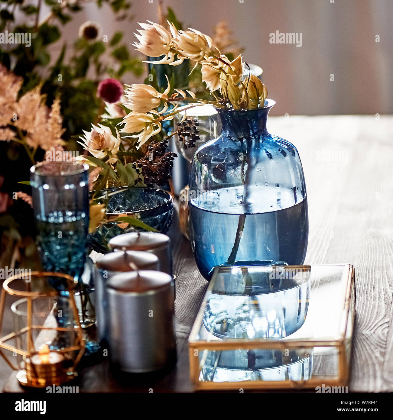 Decoration table newlyweds, blue dishes, bottles of flowers and candles.Wedding floristry. Stock Photo