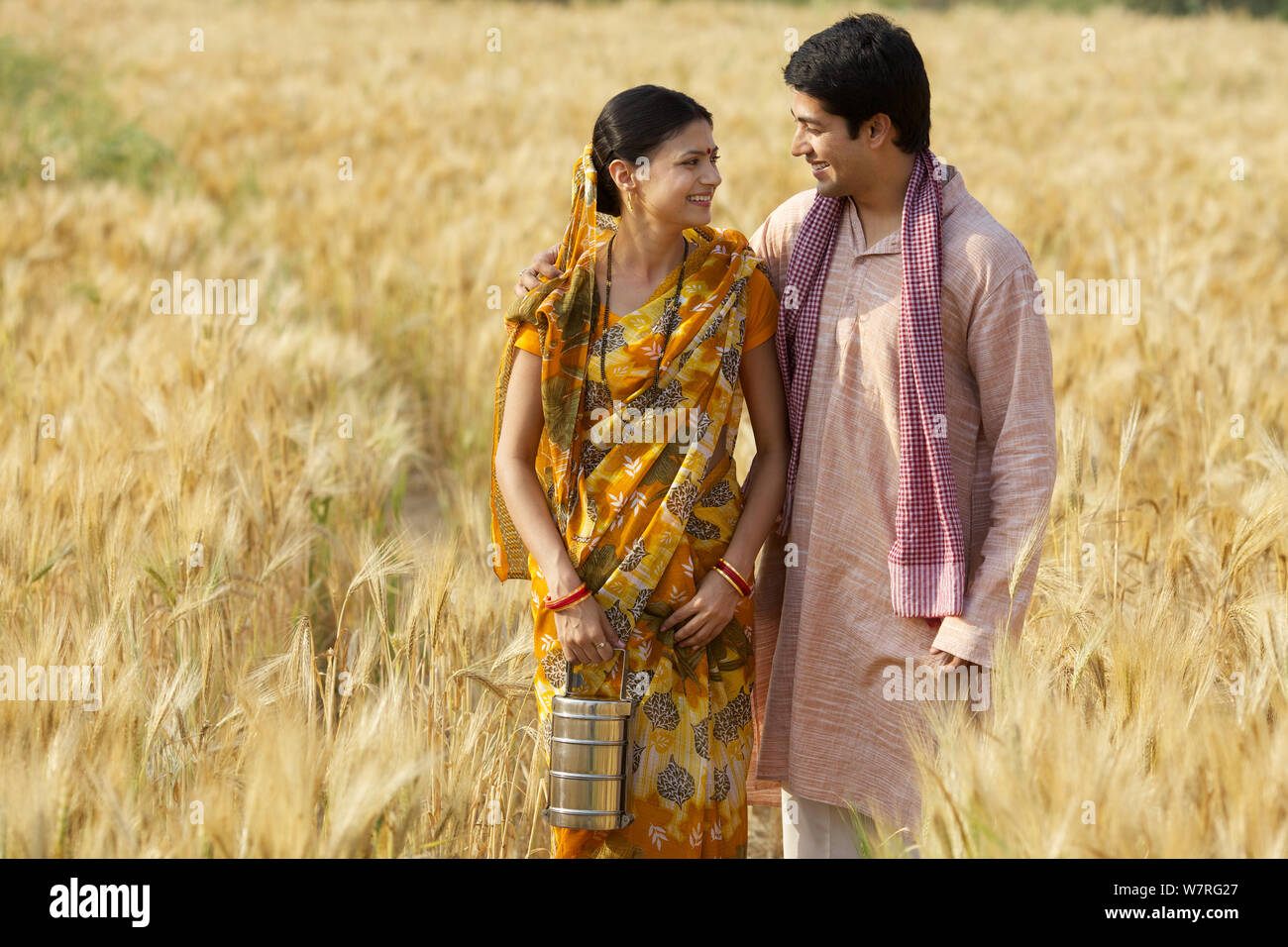 Rural couple standing together in an agricultural field Stock Photo - Alamy