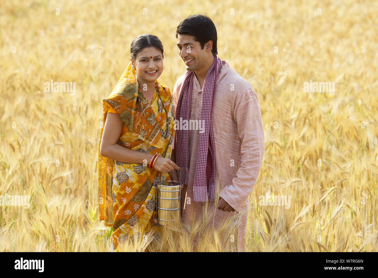 Rural couple standing together in wheat crop field Stock Photo - Alamy