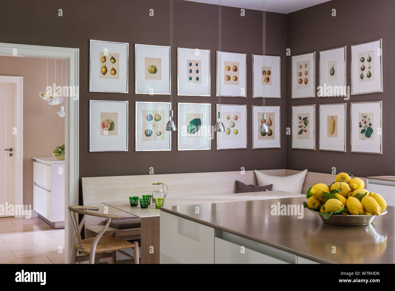 Lemons on kitchen counter by illustrations over dining area Stock Photo