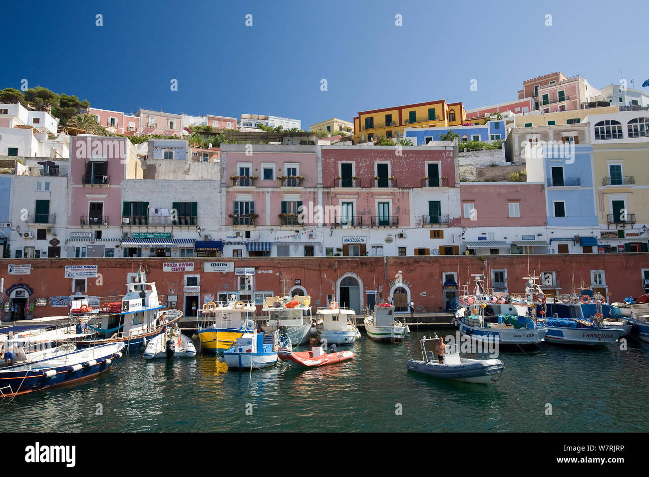 Colorful houses and fisherman boat inside Ponza's harbour, Ponza Island, Italy, Tyrrhenian Sea, Mediterranean, July 2008 Stock Photo
