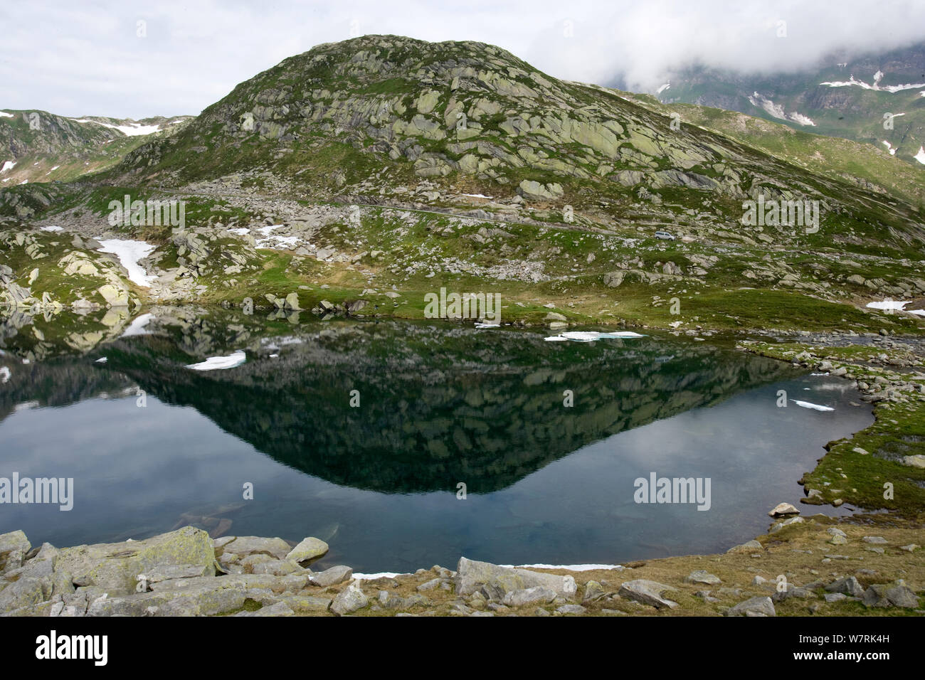 Hill reflecting in the Lake Sassolo, Sambuco valley, Ticino, Switzerland Stock Photo