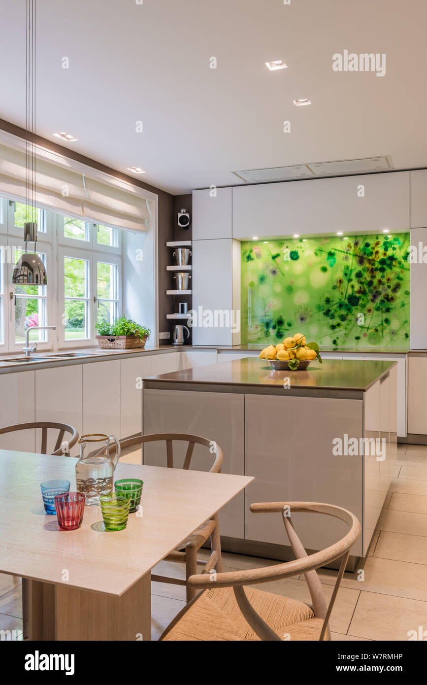 Dining area and kitchen with green splashback Stock Photo