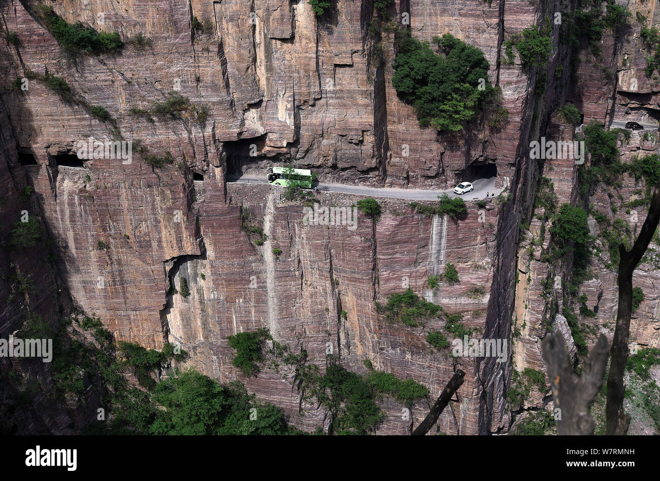Vehicles pass along the Guoliang Tunnel through the Wanxian Mountain in the Taihang Mountains in Huixian county, Xinxiang city, central China's Henan Stock Photo