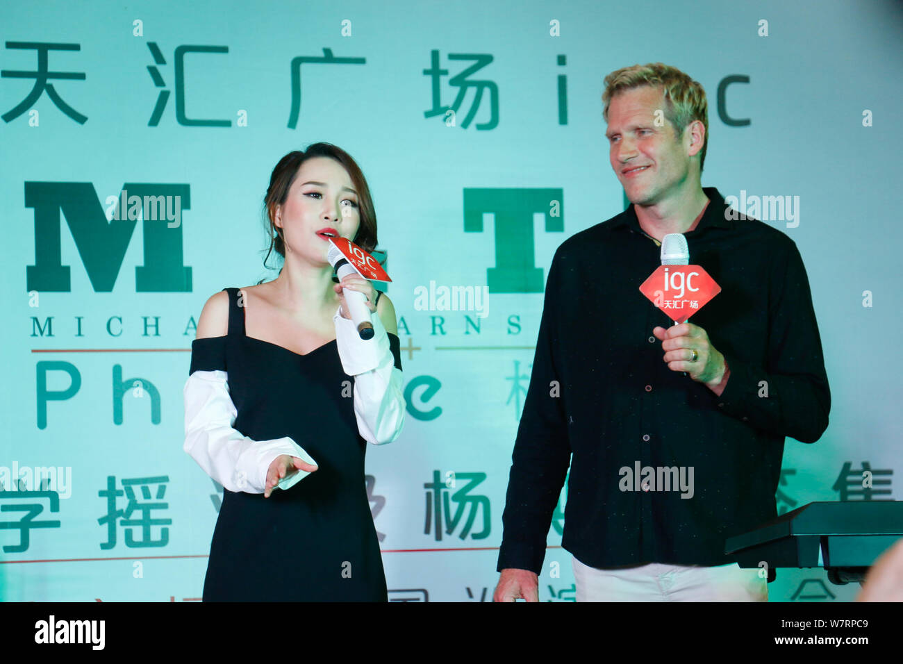 Jascha Richter, right, of Danish rock band Michael Learns to Rock (MLTR) and Chinese singer Phoebe Yang or Yang Sijie perform during a press conferenc Stock Photo