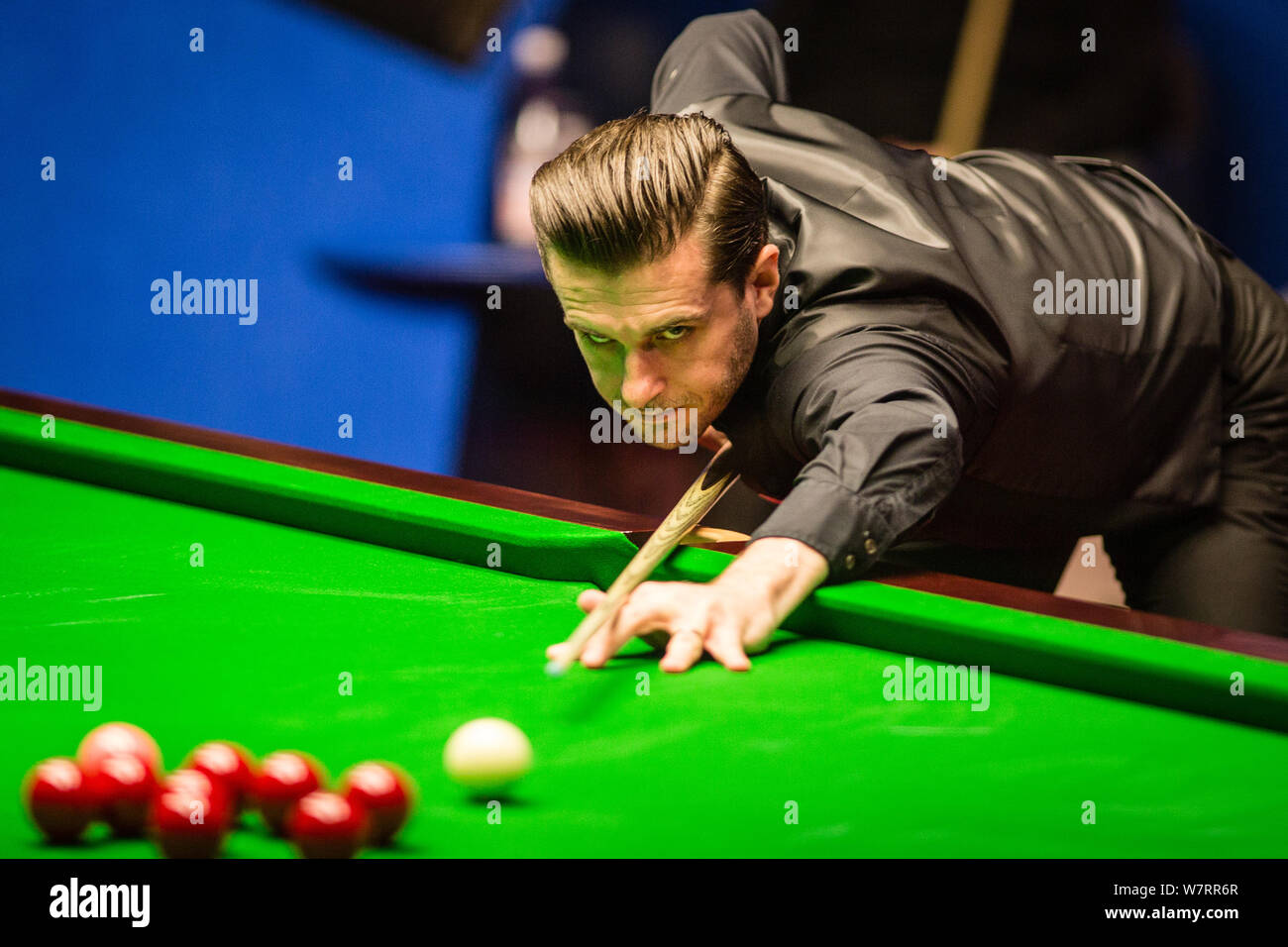 Mark Selby of England plays a shot to John Higgins of Scotland in their final match during the 2017 Betfred World Snooker Championship at the Crucible Stock Photo
