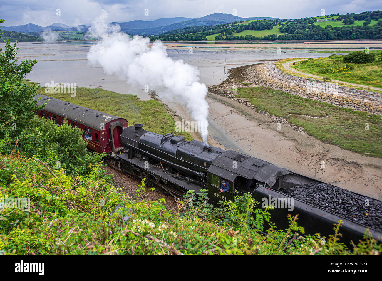 The river Conwy in Conwy Valley. Two Stanier Black Five steam locomotives hauling a railtour to mark the reopening of the line after floods. The Conwy Stock Photo