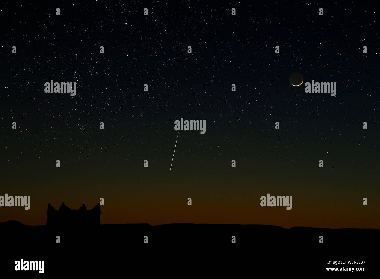 New moon and geminid meteor seen from Zagora, Morocco. December 2012 Stock Photo