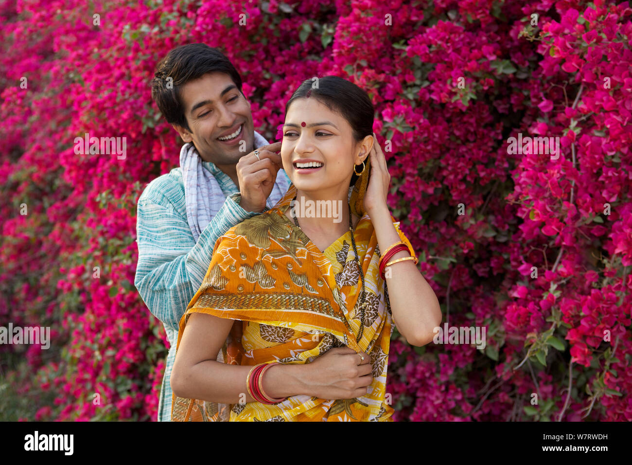 Rural man putting flower in his wife's hair Stock Photo - Alamy