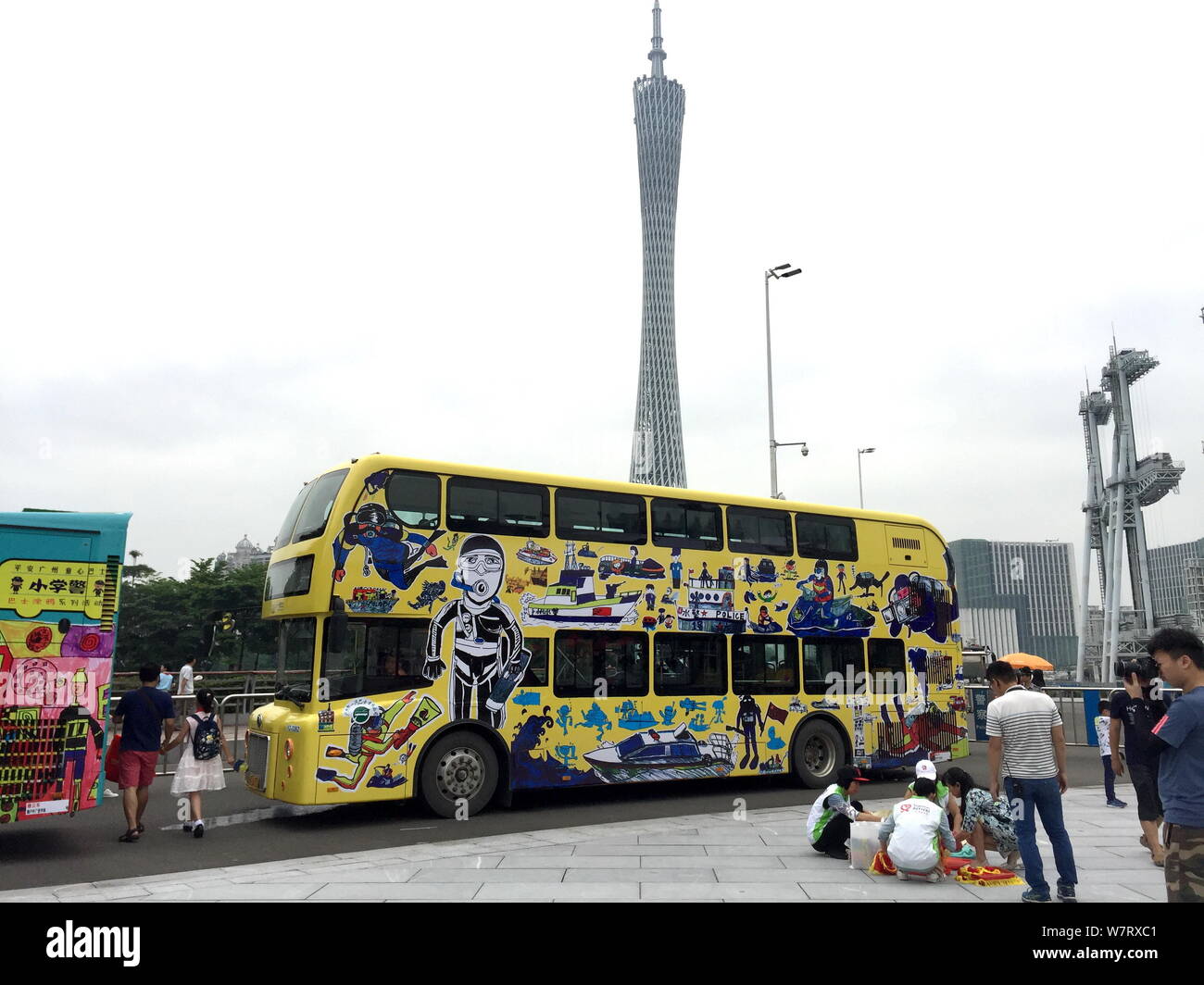 Locals look at a police-themed bus painted by 75 children ahead of the International Children's Day in Guangzhou city, south China's Guangdong provinc Stock Photo