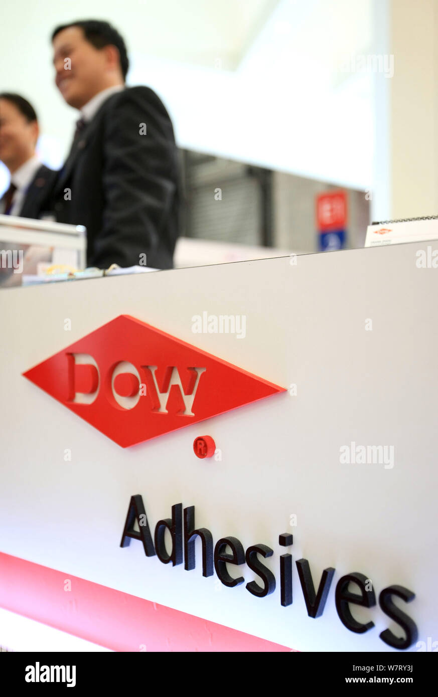 --FILE--Chinese employees are seen at the stand of Dow Chemical during an exhibition in Shanghai, China, 3 December 2009.   China has decided to green Stock Photo