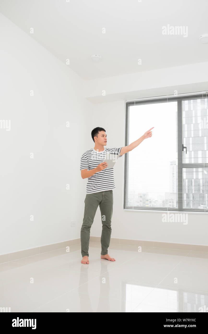 concept of moving, buying home. young man plans to repair and a project apartment Stock Photo