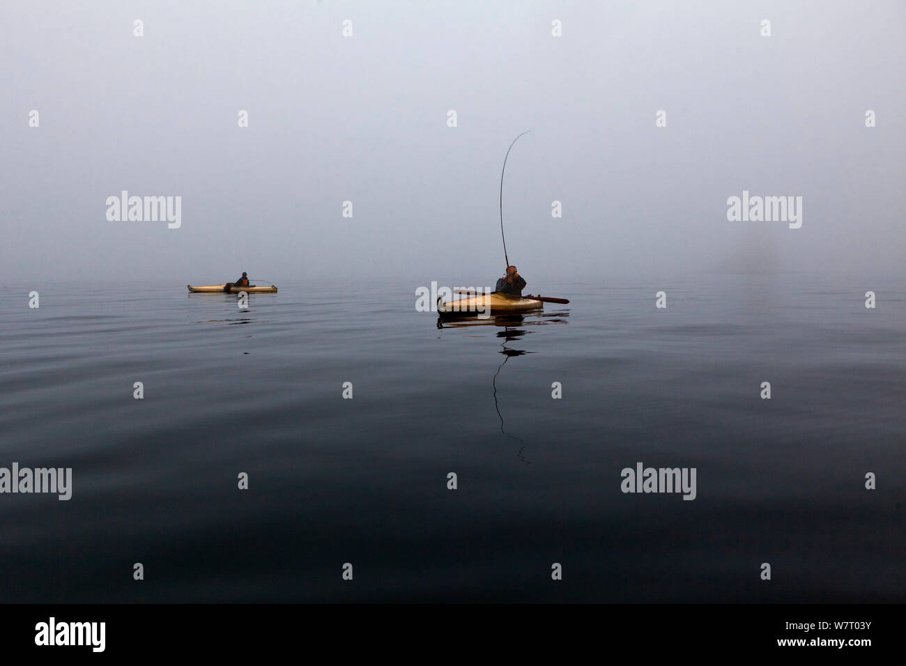 Men kayak fishing on a foggy morning in the Strait of Juan de Fuca, Washington, USA, August 2013. Model released. Stock Photo
