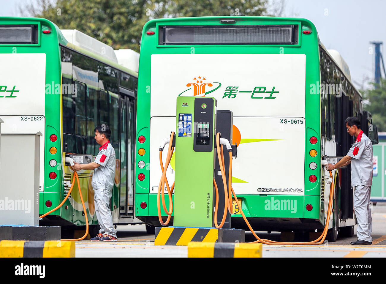 FILE Chinese workers recharge electric buses at a bus charging