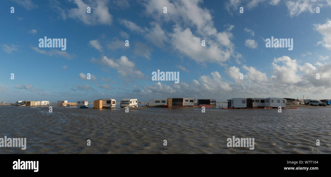 Caravans flooded by the sea on the beach of Piemanson, Arles, Camargue, France. May 2013. Stock Photo