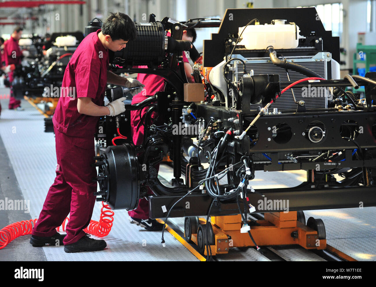 --FILE--Chinese workers assemble cars on the assembly line at an auto ...