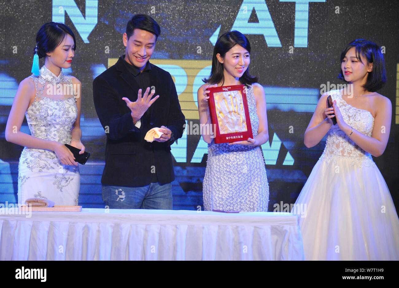 Thai actor Nawat Kulrattanarak, second left, better known by his stage