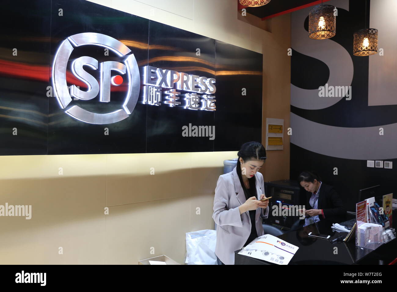 --FILE--Chinese employees are pictured at a branch of SF Express in Shanghai, China, 21 April 2017.   SF Holding Ltd said on Friday (26 May 2017) it i Stock Photo